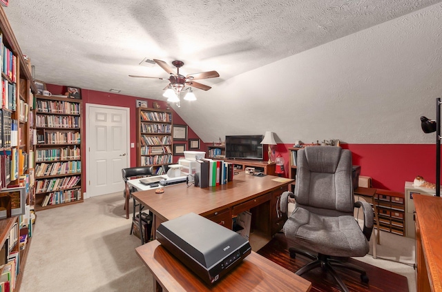 office space with lofted ceiling, carpet floors, a textured ceiling, and ceiling fan