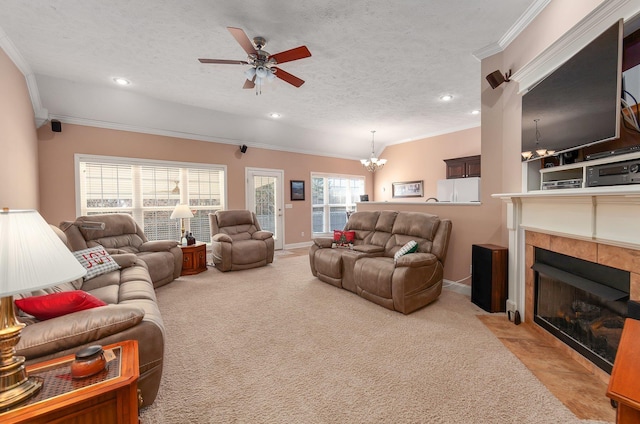 living room featuring a tile fireplace, light carpet, a textured ceiling, and ornamental molding