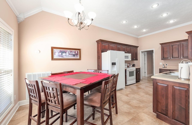 dining area with sink, a notable chandelier, and ornamental molding