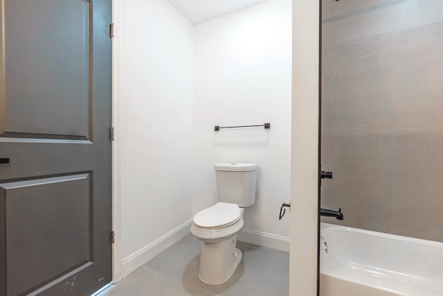 bathroom featuring tile patterned flooring, toilet, and bathtub / shower combination