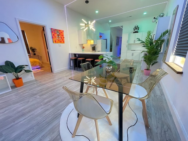 dining space with light hardwood / wood-style floors