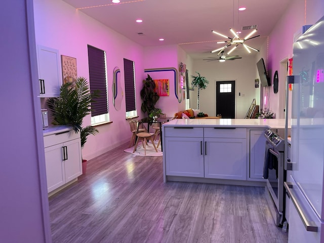 kitchen with white cabinets, a healthy amount of sunlight, and light wood-type flooring