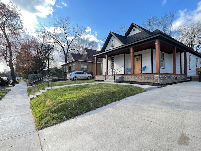 view of property exterior with a porch and a yard