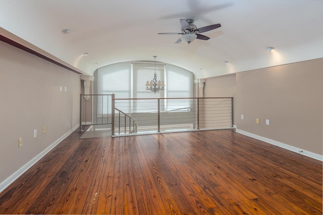 unfurnished living room featuring ceiling fan with notable chandelier, dark hardwood / wood-style flooring, and lofted ceiling