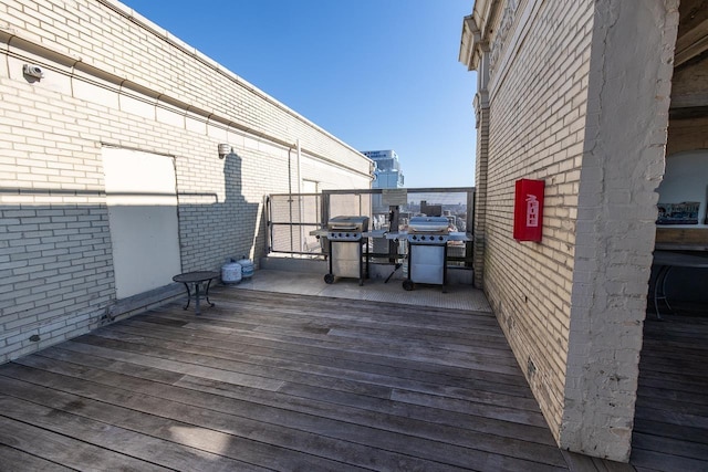 wooden terrace featuring area for grilling