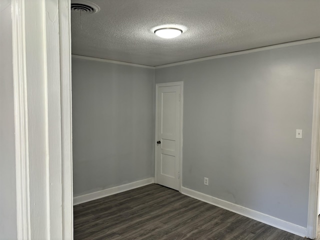 unfurnished room featuring ornamental molding, a textured ceiling, and dark wood-type flooring