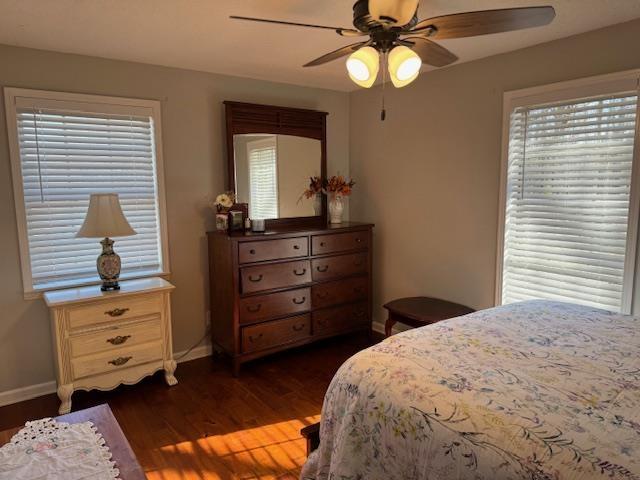 bedroom featuring ceiling fan and dark wood-type flooring