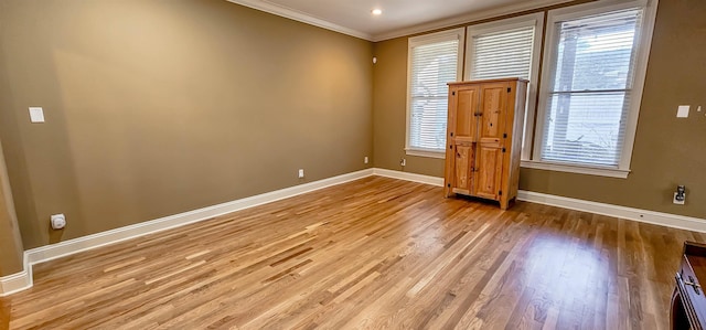 unfurnished room featuring crown molding and light hardwood / wood-style flooring