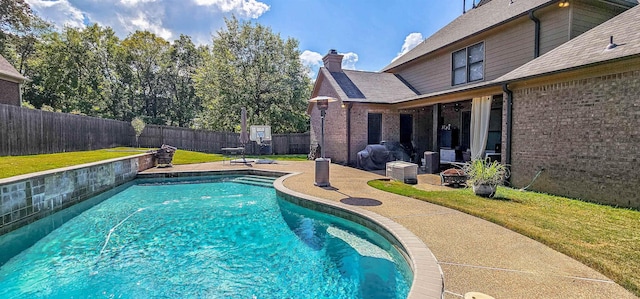 view of pool with a yard