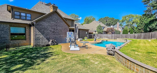 view of pool with a yard and a patio