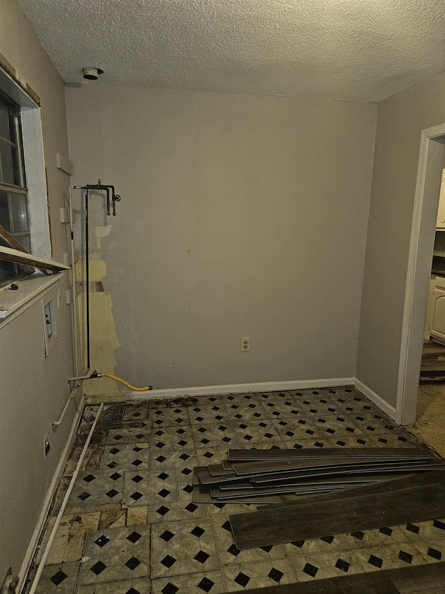 laundry room with a textured ceiling