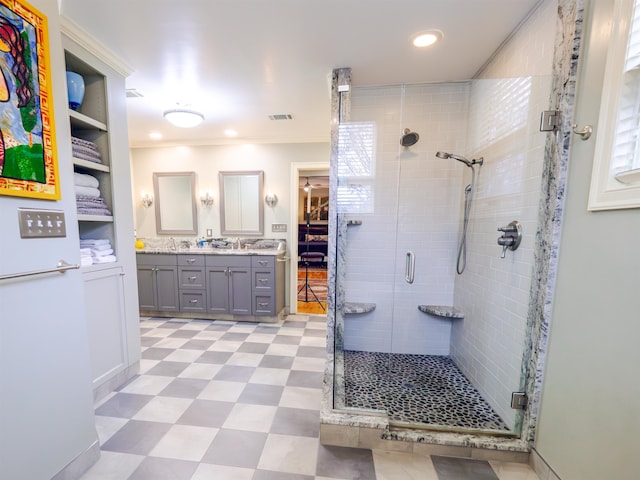 bathroom with crown molding, a shower with door, and vanity