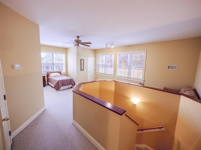 unfurnished bedroom with ceiling fan and light carpet