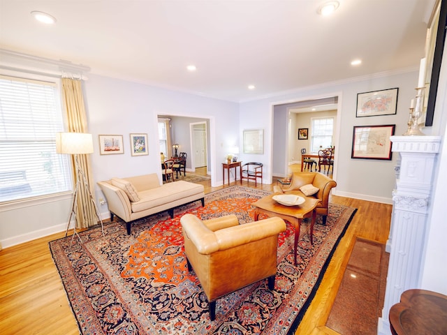 living room featuring light hardwood / wood-style flooring and ornamental molding