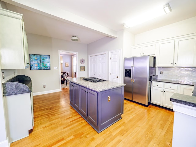 kitchen featuring white cabinetry, a center island, light hardwood / wood-style floors, and appliances with stainless steel finishes