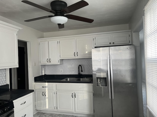 kitchen with stainless steel fridge with ice dispenser, tasteful backsplash, white cabinetry, and sink