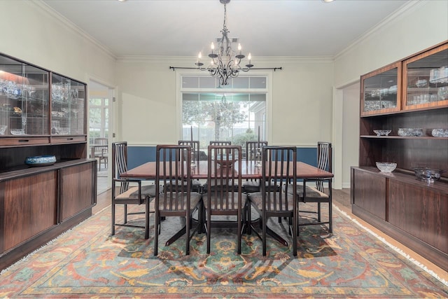 dining room with ornamental molding, plenty of natural light, and a chandelier