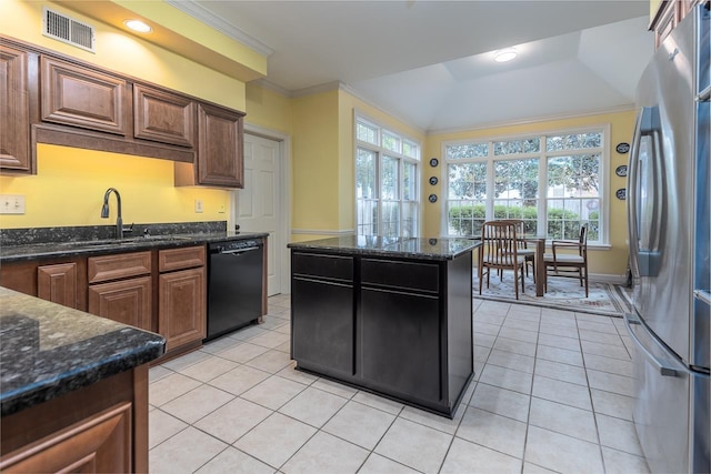 kitchen with stainless steel fridge, black dishwasher, sink, and dark stone countertops