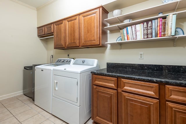 laundry room with cabinets, crown molding, light tile patterned flooring, and independent washer and dryer