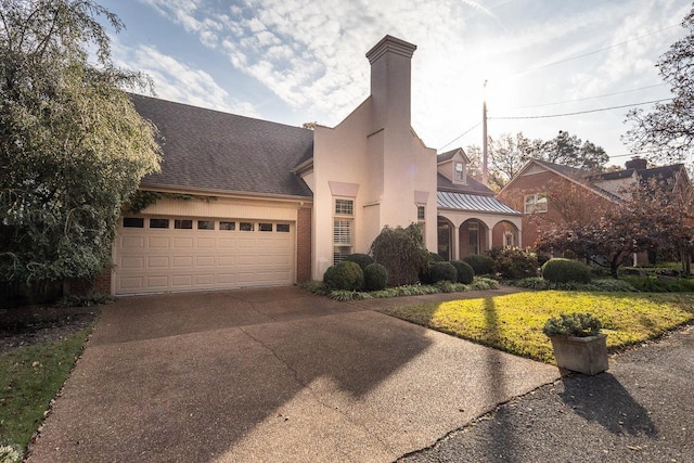 view of front of home featuring a garage and a front lawn