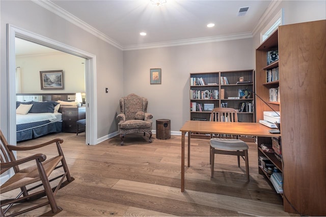 office area with hardwood / wood-style flooring and crown molding