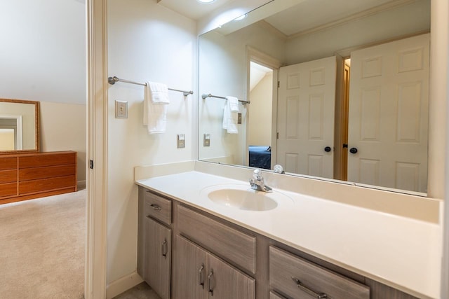 bathroom with ornamental molding, vanity, and vaulted ceiling