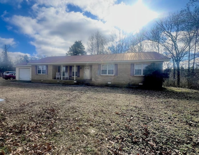 single story home with covered porch and a garage