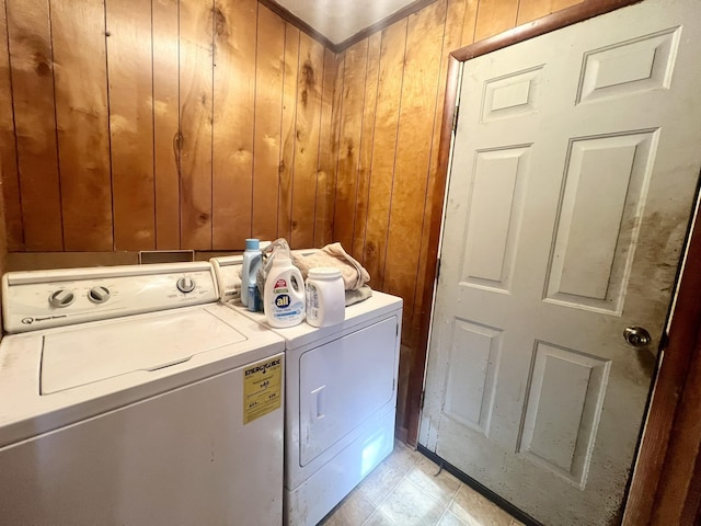 washroom featuring wood walls and separate washer and dryer