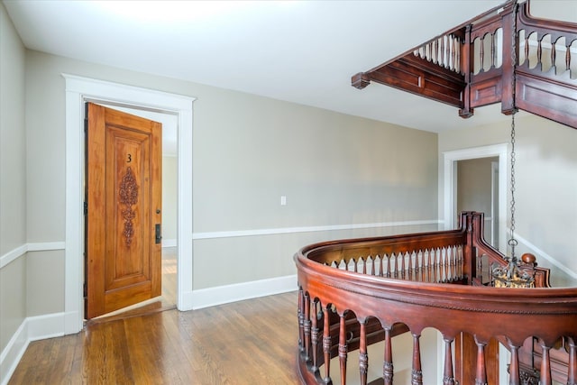 stairway with hardwood / wood-style flooring