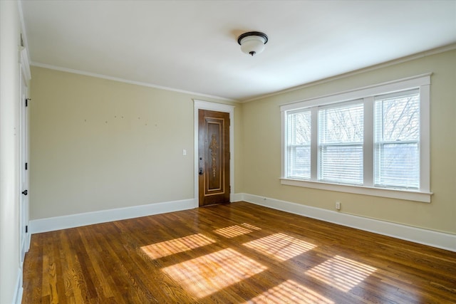 empty room with crown molding and dark wood-type flooring