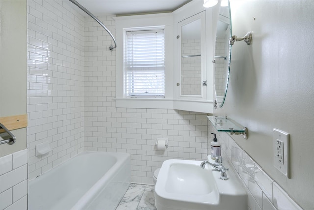 full bathroom with toilet, sink, tiled shower / bath, and tile walls