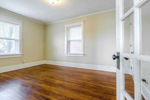 spare room with dark hardwood / wood-style floors and crown molding