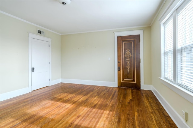 empty room featuring dark hardwood / wood-style floors and ornamental molding