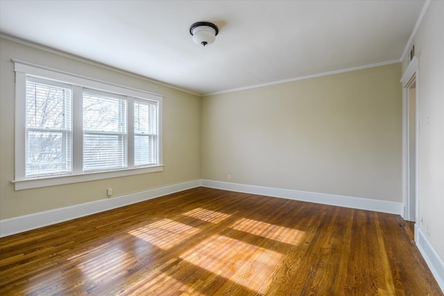 unfurnished room with dark wood-type flooring and ornamental molding