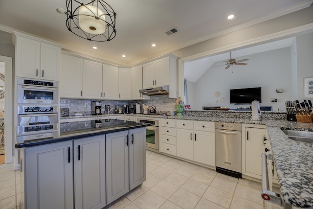 kitchen with ceiling fan, white cabinetry, hanging light fixtures, and tasteful backsplash