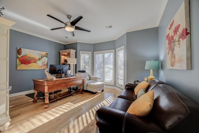 office space featuring crown molding, light hardwood / wood-style flooring, and ceiling fan