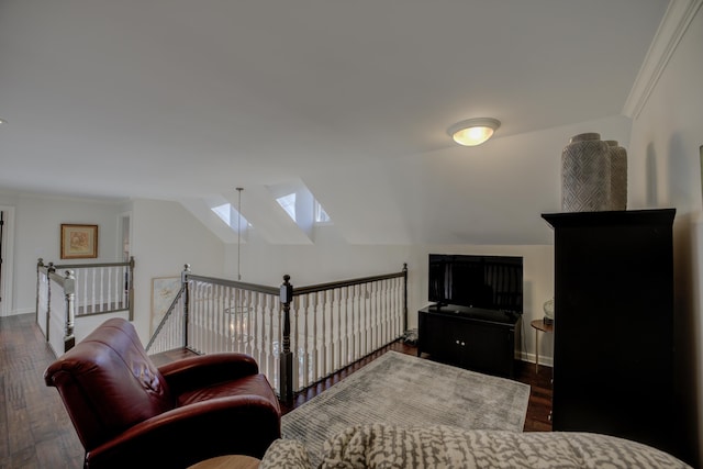 living area with crown molding, dark hardwood / wood-style flooring, and vaulted ceiling with skylight