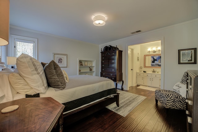 bedroom featuring wood-type flooring, connected bathroom, crown molding, and sink