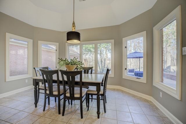 tiled dining room with a tray ceiling