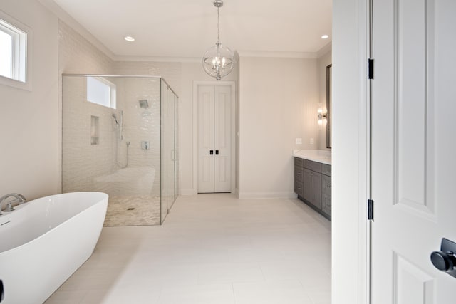 bathroom featuring plus walk in shower, vanity, and a notable chandelier