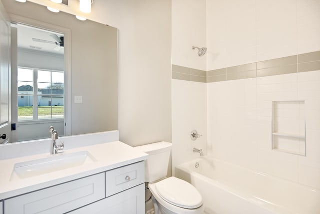 full bathroom featuring vanity, ceiling fan, toilet, and tiled shower / bath