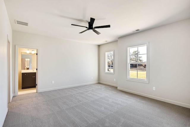 empty room featuring light carpet and ceiling fan