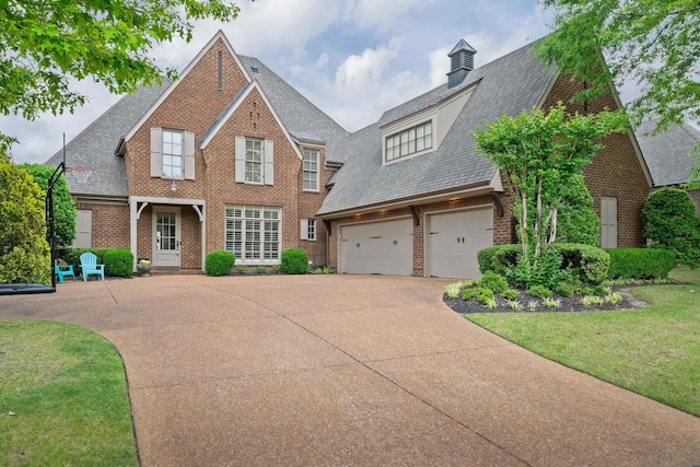 view of front of property featuring a garage and a front lawn