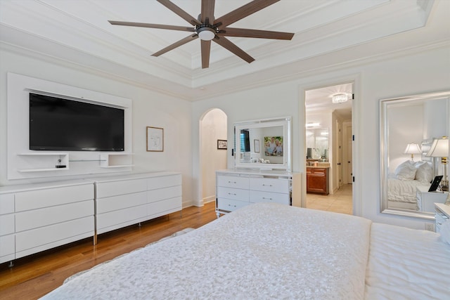 bedroom with ceiling fan, crown molding, and light wood-type flooring