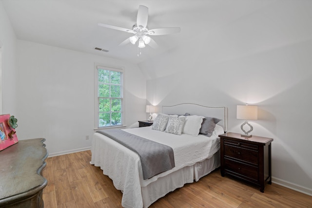 bedroom featuring ceiling fan, light hardwood / wood-style flooring, and vaulted ceiling