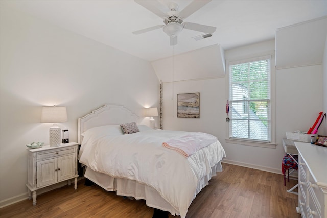 bedroom with ceiling fan, hardwood / wood-style floors, and lofted ceiling