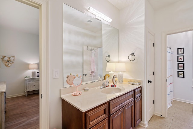 bathroom with tile patterned flooring and vanity