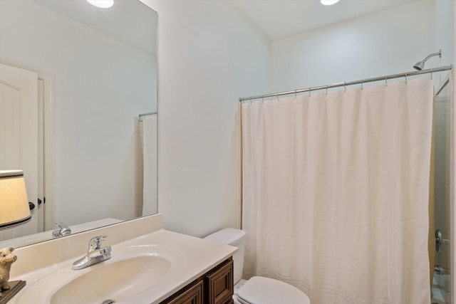 bathroom featuring vanity, curtained shower, and toilet