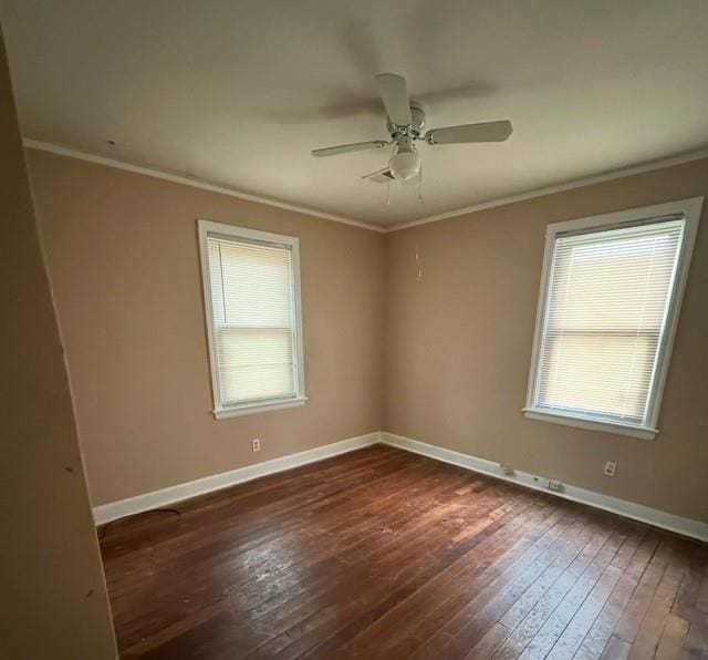 empty room with ceiling fan, dark hardwood / wood-style flooring, and crown molding