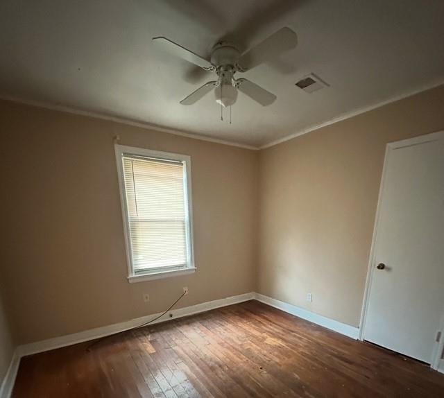 empty room with hardwood / wood-style flooring, ceiling fan, and crown molding